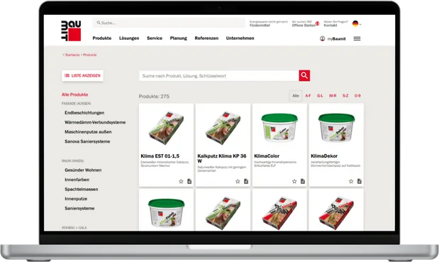 **Bildbeschreibung:**

Ein moderner Laptop zeigt die Website einer IT-Agentur, die spezialisiert auf den Verkauf und die Beratung von Baustoffen ist. Auf dem Bildschirm sind Produktbilder von verschiedenen Bauprodukten zu sehen, präsentiert in einem struk