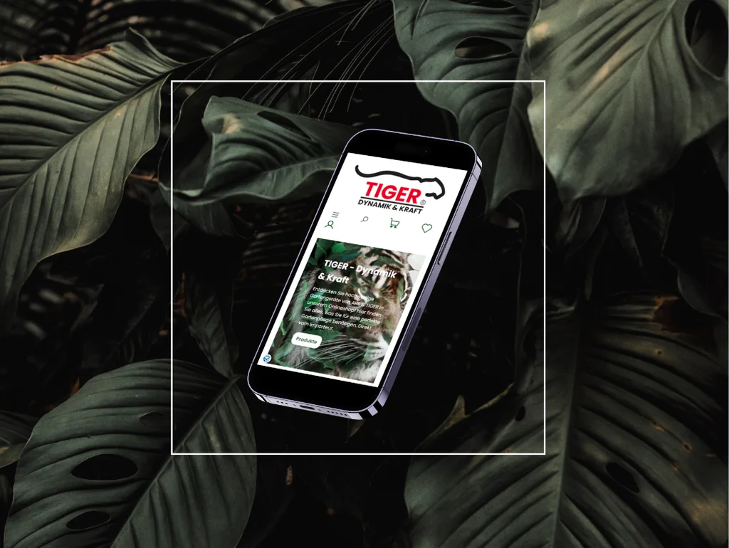 Smartphone zeigt „Tiger“ Anwendung vor tropischen Blättern, auf schwarzem Hintergrund platziert.